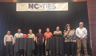 Group on stage at NC Ties awards